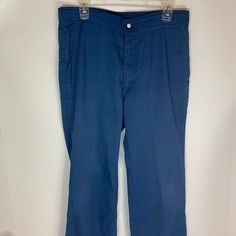 "Levi pants (not denim) in good vintage condition. Made \"with a skosh more room\". Featuring metal snaps and thick quality cotton material. Size 34/34" Cotton Denim Blue Bottoms With Button Closure, Denim Blue Cotton Bottoms With Button Closure, Dark Wash Cotton Bottoms With Button Closure, Washed Blue Cotton Pants, Classic Washed Blue Bottoms With Pockets, Medium Wash Cotton Bottoms With Button Closure, Washed Blue Cotton Pants With Belt Loops, Dark Wash Cotton Pants With Button Closure, Retro Style Denim Blue Cotton Pants