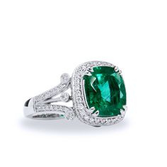 Turn the world green with envy wearing this gorgeous 4.09 carat GIA certified cushion cut Zambian Emerald ring, decorated with 0.71 carats in total weight of diamonds (G/H - VS) all displayed on an 18 karat white gold split shank band. SKU: 15475 Luxury Cushion Cut Emerald Ring With Diamond, Luxury Green Cushion Cut Jewelry, Luxury Green Cushion Cut Emerald Ring, Luxury Green Cushion Cut Diamond Ring, Green Cushion Cut Diamond Ring With Center Stone, Cushion Cut Emerald Ring For Formal Occasions, Gia Certified Green Cushion Cut Rings, Gia Certified Green Cushion Cut Jewelry, Green Cushion Cut Diamond Jewelry