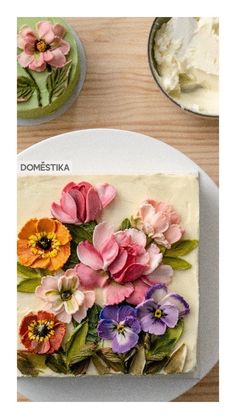 there is a piece of cake decorated with flowers on the top and bottom, sitting on a plate