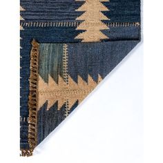 a blue and beige rug with fringes on it