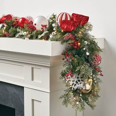 a fireplace mantel decorated with christmas decorations