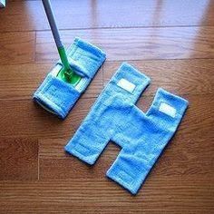 a mop is laying on the floor next to two blue towels with holes in them