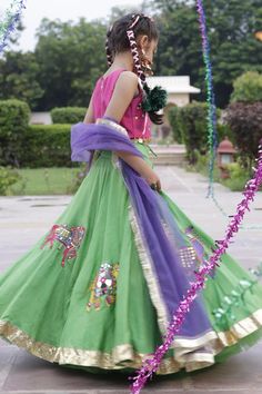 Green flared lehenga in silk blend base with baraat embroidery. Paired with pink sleeveless mirror embroidered blouse with coin medallion embellishments on the hem and purple gota embellished dupatta.
Components: 3
Pattern: Embroidery
Type Of Work: Baraat, Mirror
Neckline: Round
Sleeve Type: Sleeveless
Fabric: Blouse: Silk Blend, Lehenga: Silk Blend, Dupatta: Net
Color: Pink, Green, Purple
Other Details: 
Note: The accessories worn by the model is not for sale
Occasion: Festive and Wedding - Aza Chanderi Sharara For Festivals, Festive Pista Green Raw Silk Lehenga, Pista Green Lehenga For Festive Eid Occasions, Festive Pista Green Choli, Pista Green Chanderi Choli With Dori Work, Green Dupatta For Festivals, Pista Green Lehenga For Festive Diwali Occasion, Festive Pista Green Lehenga For Diwali, Pista Green Art Silk Party Sets