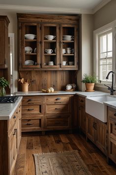 a kitchen filled with lots of wooden cabinets and counter top space next to a sink