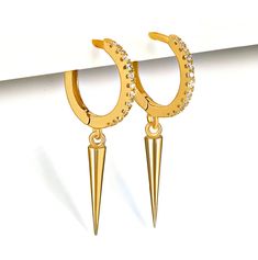 Express yourself with standout Gold Spike dangle earrings. Tiny cubic zirconia crystals inserted in the hoops make them a sparkling beauty. These small Spike charm hoops stand out wearing alone, and they also are perfect when styled with other earrings. Available in Sterling silver and Gold plated. M A T E R I A L S * A N D * D E T A I L S - Sterling Silver - 14K GOLD plated (gold over silver) D I M E N T I O N S 10 mm hoops 13 mm Cone spike drop H O W * T O * O R D E R Choose Silver or Gold opt Hoop Crystal Earrings With Cubic Zirconia For Pierced Ears, Pierced Dangle Hoop Earrings In Cubic Zirconia, Earrings Small Hoop, Dainty Initial Necklace, Gold Starburst, Dainty Hoop Earrings, Dangle Earrings Boho, Starburst Earrings, Small Hoop Earrings