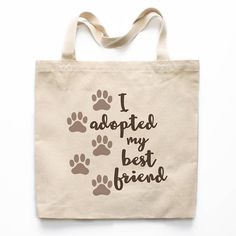 a tote bag that says i adopted my best friend with paw prints on it