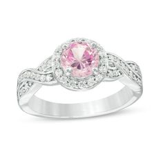 a pink and white diamond ring on a white background with the center stone surrounded by diamonds