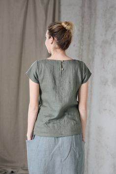 * 100% soft linen * Short sleeve * 2 buttons at the back * Handmade in Slovakia * The model is 176 cm tall, wearing size S, color Olive (this color is no longer available) Measurements: Size XS - cloth (laid on the floor): Bust: 42 cm Length (from the neckline to the hem measured from the back): 56 cm -------------------------- Size S - cloth (laid on the floor): Bust: 44 cm Length (from the neckline to the hem measured from the back): 58 cm --------------------------- Size M - cloth (laid on th Linen Blouse With Buttons, Green Linen Crew Neck Top, Flax Colored Tops With Buttons And Relaxed Fit, Casual Flax Linen Top, Relaxed Fit Flax Top With Buttons, Relaxed Fit Flax Colored Top With Buttons, Casual Flax Top With Buttons, Casual Buttoned Beige Tops, Relaxed Fit Linen Blouse