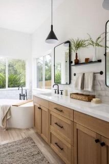 a large bathroom with two sinks and mirrors