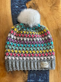 a crocheted hat with a pom - pom on top