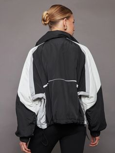 Esme Anorak - Black/ Soft White/ Reflective – Carbon38 Ski Windbreaker With Detachable Hood, Sporty Outerwear For Ski Season, Sporty Nylon Windbreaker For Skiing, Sporty Nylon Windbreaker For Ski Season, Sporty Windproof Windbreaker For Ski Season, Functional Nylon Windbreaker For Ski Season, Spring Showers, Ski Club, Carbon 38