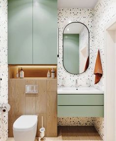 a bathroom with a toilet, sink and mirror in it's center wall area