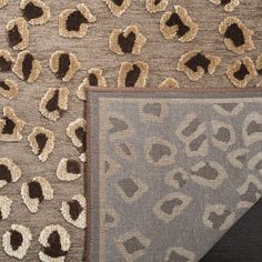 two rugs with animal prints on them, one in grey and the other in brown