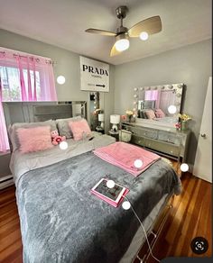 a bed room with a neatly made bed and pink pillows