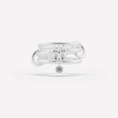 The Piera linked ring is comprised of three linked bands and features a trio of annulets with a central drop charm. Each ring in either 18k gold or .925 sterling silver is paired with a bezel-set stone in striking contrast and tactile appeal. Each Piera linked ring is individually handmade in Los Angeles. Modern Twist White Gold Jewelry With Ring Detail, Timeless Silver Stackable Rings With Bezel Setting, Timeless Double Band Ring With Detail, Timeless Double Band Ring Jewelry, White Gold Jewelry With Double Band Ring Detail, Timeless Silver Stackable Double Band Rings, Timeless Silver Double Band Stackable Rings, Linked Rings, Galaxy Ring