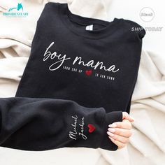 "❤️ This sweatshirt, humorously embroidered with \"Boy Mama\" and personalized with her kid's name, celebrates the fun, challenges, and unconditional love of raising boys. Perfect for the mom who tackles every mess and mischief with a smile. Show her how much you value her endless energy and love with a gift that's as special and unique as her role. Ideal for the superhero mom who deserves a day filled with laughter, relaxation, and recognition. ❤️ P R O D U C T * I N F O Minimalistic, casual, a Custom Text Long Sleeve Sweatshirt As A Gift, Customizable Long Sleeve Sweatshirt For Father's Day, Cotton Sweatshirt With Lettering For Gift, Mother's Day Sweatshirt With Custom Text, Father's Day Cotton Sweatshirt With Name Print, Customizable Long Sleeve T-shirt For Father's Day, Personalized Black Crew Neck Sweatshirt, Long Sleeve Sweatshirt With Lettering As Gift, Personalized Cotton Sweatshirt For Mother's Day