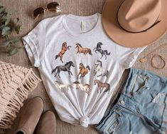 Beautiful Horses tee. I like to dress up these t-shirts with a nice denim jacket. For our Tee shirts we use the Bella Canvas brand. Our unisex tees are super soft 100% Airlume combed and ring-spun cotton. (Heather Peach:52% Airlume combed and ring-spun cotton, 48% poly. Athletic Heather:90% Airlume combed and ring-spun cotton, 10% poly.) Sweatshirt details: 50% Cotton 50% Polyester, Medium-heavy fabric (8.0 oz/yd² (271.25 g/m Loose fit, Runs true to size. *Please make sure you check our size-chart before you place your order.* If you have any questions feel free to message us 😊 HOW TO ORDER 1. Please, Check and Review all Photos. 2. Select Your T-Shirt Size and T-Shirt Color from drop down menus. 3. Choose Your Quantity as much as you want. 4. Click ADD TO CART. If you are ordering more t Western Style T-shirt For Ranch In Summer, Western Style Summer T-shirt, Casual Summer T-shirt For Ranch, Casual Summer Outdoor T-shirt, Western Style T-shirt For Spring Ranch, Western Pre-shrunk Tops For Summer, Casual Shirt For Country Events In Fall, Country Style T-shirt For Rodeo In Spring, Western Style Shirt For Ranch In Summer