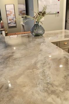 a kitchen counter with a vase filled with flowers