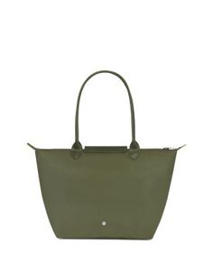 a green handbag is shown on a white background and it has a long handle