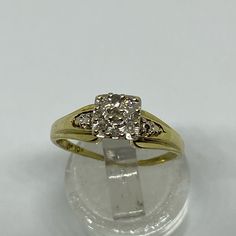 a diamond ring sitting on top of a clear object