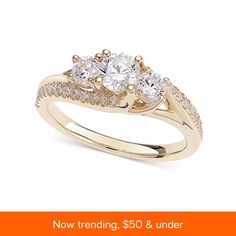 three stone engagement ring with the words now trending $ 50 & under on it