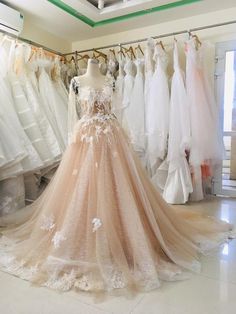 a dress on display in a store with other dresses hanging from the racks behind it