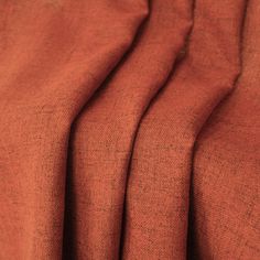 an orange cloth is folded up and ready to be used as a background or wallpaper