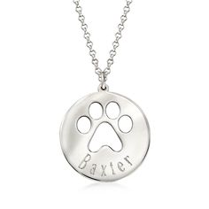 a dog paw necklace with the word baxter engraved on it