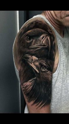 a man's arm with an eagle tattoo on it and the image of two birds in