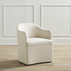 a white chair sitting on top of a hard wood floor