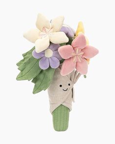 a bouquet of flowers in a sock with a smile on its face is shown against a white background