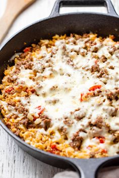 a skillet filled with cheese and ground beef