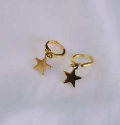 ♥ The cutest dainty gold star huggie hoop earrings 14k Gold Filled Earrings With Star Charm As Gift, Dainty Hoop Earrings With Star Charm, Dainty Star-shaped Hoop Earrings For Everyday, Gold Dainty Cartilage Earrings With Star Charm, Dainty Gold Cartilage Earrings With Star Charm, Trendy Gold Earrings With Star Charm, Gold Star-shaped Dainty Cartilage Earrings, Gold Dainty Star Cartilage Earrings, Star-shaped Tarnish Resistant Hoop Earrings For Everyday