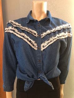 "Cute shirt. Love it tied over a sundress. Light Chambray denim. 3/4 length sleeves. Great condition. Medium Length 24\" Shoulders 28\" Sleeves 29\" Bust 39\" Waist 38\"" Spring Button-up Denim Top With Frayed Hem, Spring Button-up Tops With Frayed Hem, Blue Long Sleeve Denim Top With Frayed Hem, Cotton Denim Top With Frayed Hem And Long Sleeves, Long Sleeve Cotton Denim Top With Frayed Hem, Long Sleeve Denim Top With Frayed Hem, Cotton Denim Top With Frayed Hem For Day Out, Fall Long Sleeve Blouse With Frayed Hem, Long Sleeve Blouse With Frayed Hem For Fall