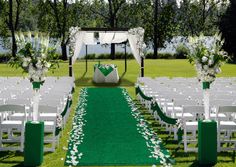 an outdoor wedding setup with pink and white flowers