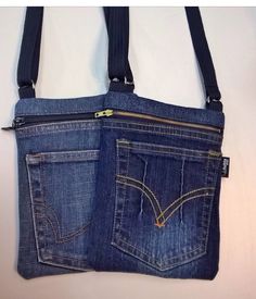 two pockets in the back of a pair of blue jeans with zippers on them