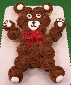 a teddy bear made out of cupcakes sitting on top of a table