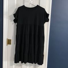 Super Cute Black Ruffle Dress. Bought This Thinking It Would Fit But It Would Fit A Medium/Large Better. Never Worn Black Dress With Ruffle Hem And Sleeve, Black Dress With Ruffle Hem And Ruffle Sleeve, Black Short Sleeve Midi Dress With Ruffle Hem, Black Midi Dress With Ruffle Sleeves, Black Casual Tiered Dress With Ruffles, Casual Black Tiered Mini Dress, Black Tiered Midi Dress With Ruffle Hem, Black Casual Tiered Mini Dress, Black Mini Dress With Ruffle Hem And Sleeves