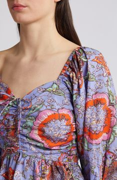 A scrunched-and-tied front gives shape to this flowery top designed with billowed sleeves and a flouncy peplum. 20 1/2" length (size medium) Sweetheart neck Three-quarter sleeves 100% organic cotton Dry clean Imported Floral Print Puff Sleeve Peasant Top For Brunch, Feminine Floral Print Peasant Top With Puff Sleeves, Multicolor Floral Print Top With Balloon Sleeves, Multicolor Blouse With Gathered Sleeves, Spring Floral Print Peasant Top With Puff Sleeves, Floral Print Peasant Top With Puff Sleeves For Spring, Floral Print Puff Sleeve Peasant Top For Spring, Multicolor Tops With Gathered Sleeves For Spring, Spring Long Sleeve Top With Gathered Neckline