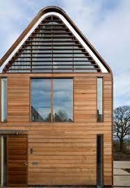 a wooden house with a sloping roof and windows