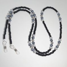 Keep your glasses or mask close by with this Beaded Chain. It is a perfect match to any outfit.  It measures approx. 28 inches. It is made with black glass beads, grey faux pearls and antique silver beads. You can choose rubber eyeglass holders, lobster claws to hold your mask, or both to be able to use it either way.  The black seed beads are tiny 4mm beads making the chain lightweight, but still very sturdy, as it is made with 49 strand jewelry wire for maximum durability. All of my items are Black Adjustable Glasses Chain For Parties, Elegant Black Glasses Chains For Party, Adjustable Beaded Necklaces With Round Beads And Chain, Adjustable Beaded Necklace With Round Beads And Chain, Black Glass Glasses Chain For Parties, Trendy Black Glass Jewelry, Adjustable Black Glasses Chains For Parties, Black Glass Chain Jewelry, Adjustable Glass Beaded Necklace With Black Beads