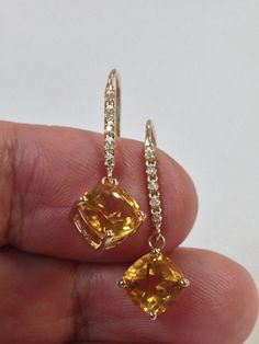 "SOLID 14KT YELLOW GOLD DANGLE EARRINGS NATURAL CITRINE IS  8x8 mm EACH NATURAL DIAMOND IS 0.15 TCW EARRING LENGTH IS   1.1/8\" INCHES WITH GIFT BOX" Yellow 14k Gold Fine Jewelry Earrings, Yellow Round Earrings With Prong Setting, Yellow Earrings With 17 Jewels For Formal Occasions, Formal Yellow Earrings With 17 Jewels, Yellow Earrings With Prong Setting For Anniversary, Yellow Gold Citrine Dangle Earrings, Fine Jewelry Yellow Earrings For Anniversary, Formal Citrine Jewelry With Diamond Cut, Orange Citrine Jewelry With Prong Setting