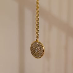 Our Crystal Medallion Necklace features a round charm with Cubic Zirconia crystals. This minimalist necklace is inspired by the beautiful night sky filled with stars and will look great layered or worn alone. This necklace is perfect for wearing on an evening out or to glam up your day time casual wear. We make our jewellery in small batches to reduce wastage. Our jewellery is designed with the modern Woman in mind, elegant, unique pieces with a classic touch. Our jewellery is great for gifting, Gold Circular Diamond Necklace, Diamond Charm Necklace With Adjustable Chain, Elegant Circular Coin Pendant Charm Necklace, Gold Necklace With Moon Charm And Cubic Zirconia, Gold Necklace With Moon Charm In Cubic Zirconia, Diamond Coin Necklace Gift, Cubic Zirconia Moon Charm Necklace, Diamond Coin Necklace For Gift, Diamond Round Coin Necklace For Gift