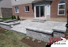 a brick patio in front of a house