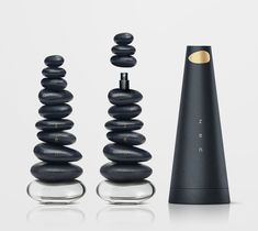 three black objects sitting on top of each other in front of a white background,