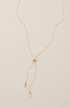 Sparkling cubic zirconia illuminate this dainty chain necklace that stands out on its own or in a layered style. 16" length; 2" extender; 1" shortest drop; 2" longest drop 14k-gold fill/cubic zirconia Made in the USA Drop Down Necklace, Cubic Zirconia Lariat Necklace With Delicate Chain, Gold Cubic Zirconia Lariat Necklace, Delicate Lariat Cubic Zirconia Necklace, Delicate Cubic Zirconia Lariat Necklace, Dainty Cubic Zirconia Lariat Necklace, Dainty Backdrop Necklace With Adjustable Chain, Dainty Long Adjustable Backdrop Necklace, Elegant Adjustable Long Charm Necklace