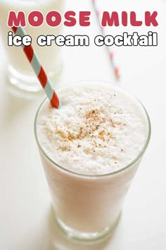 a glass filled with ice cream sitting next to two glasses full of milk and strawberries