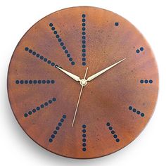 a brown clock with blue dots on it