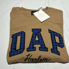 a t - shirt with the word dad written in blue ink on it and a tag hanging from the front