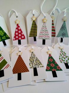 christmas tree gift tags are hanging on the wall